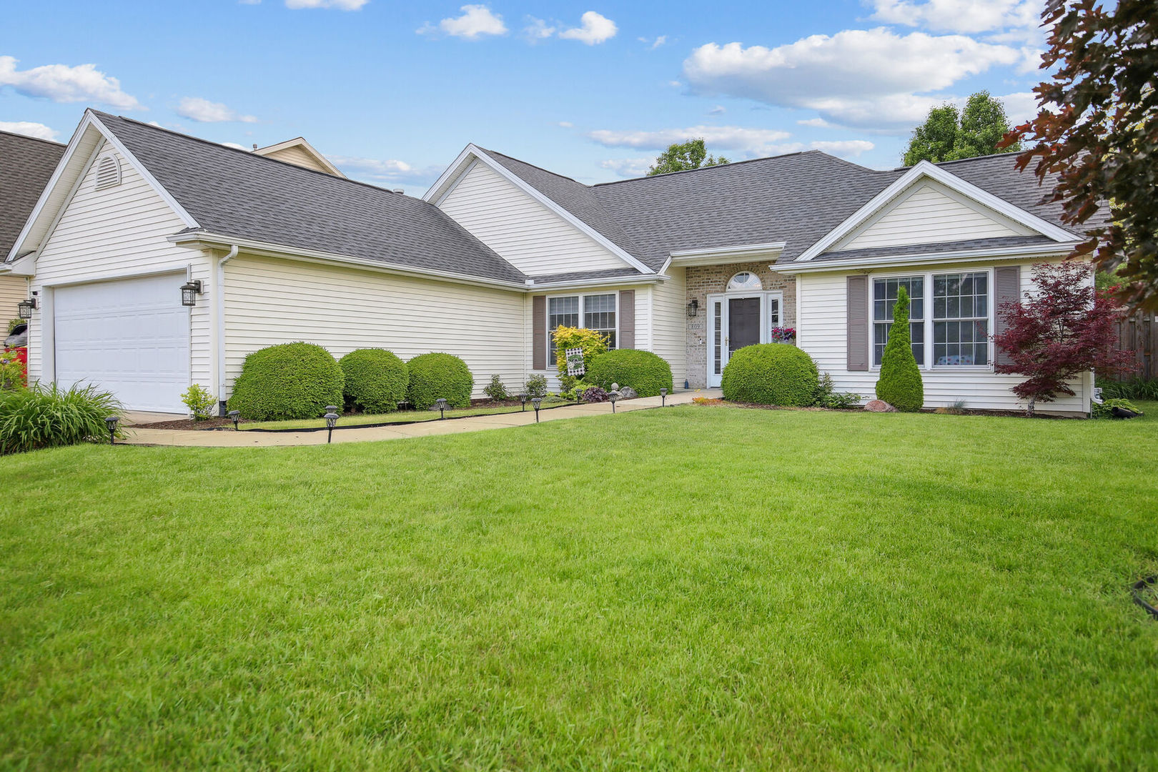 a front view of a house with garden