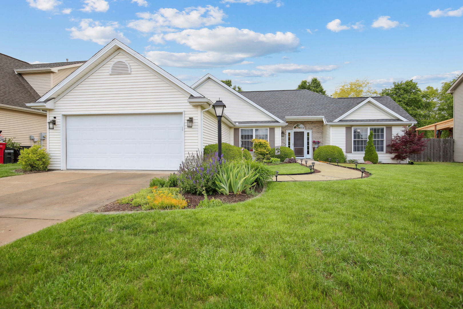 809 Lavender Drive Savoy, IL 61874 - Photo 26 of 27 a front view of a house with a yard and garage