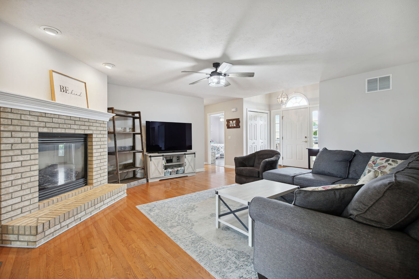 809 Lavender Drive Savoy, IL 61874 - Photo 5 of 27 a living room with furniture a flat screen tv and a fireplace