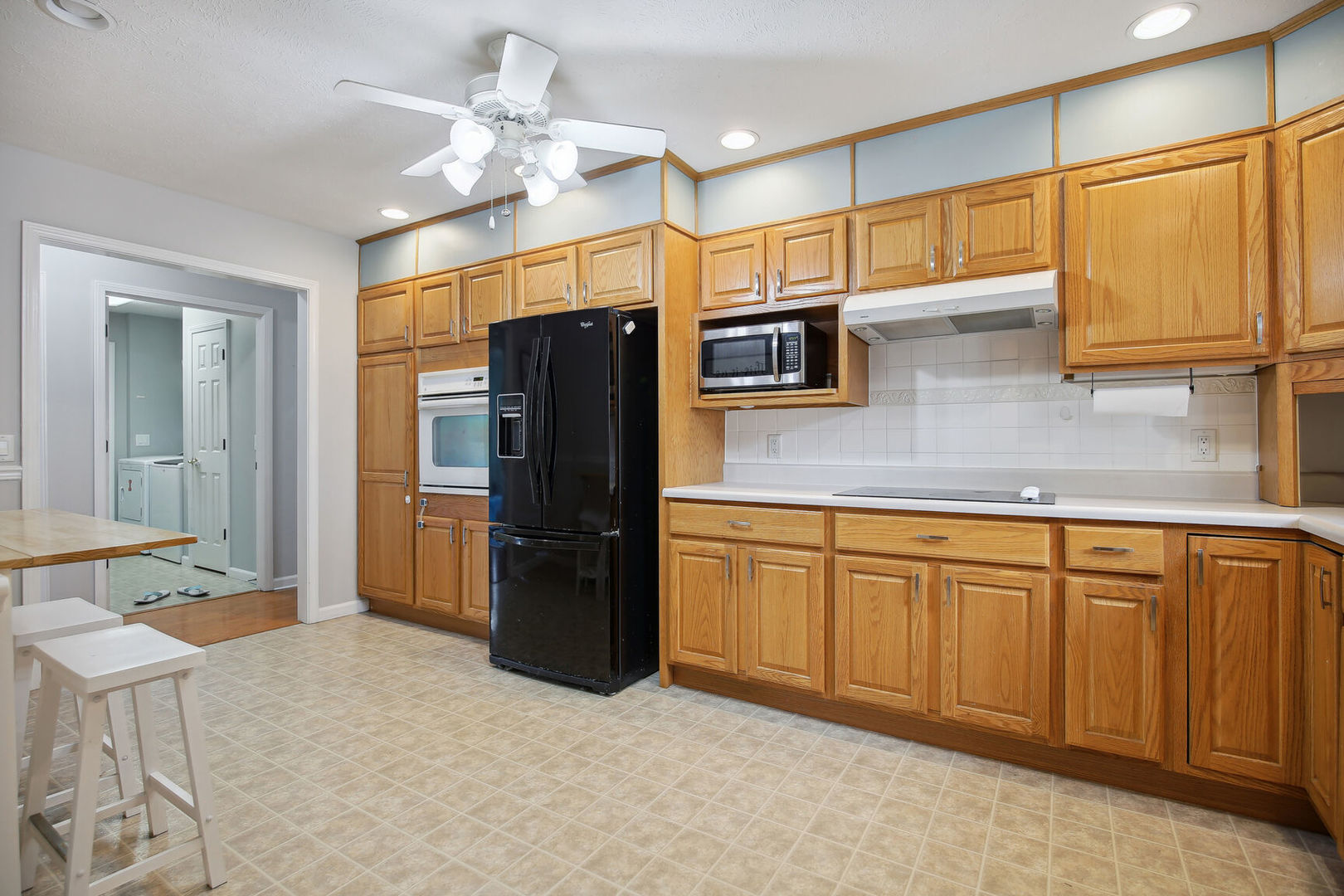 809 Lavender Drive Savoy, IL 61874 - Photo 7 of 27 a kitchen with stainless steel appliances granite countertop a refrigerator a stove and a sink with cabinets