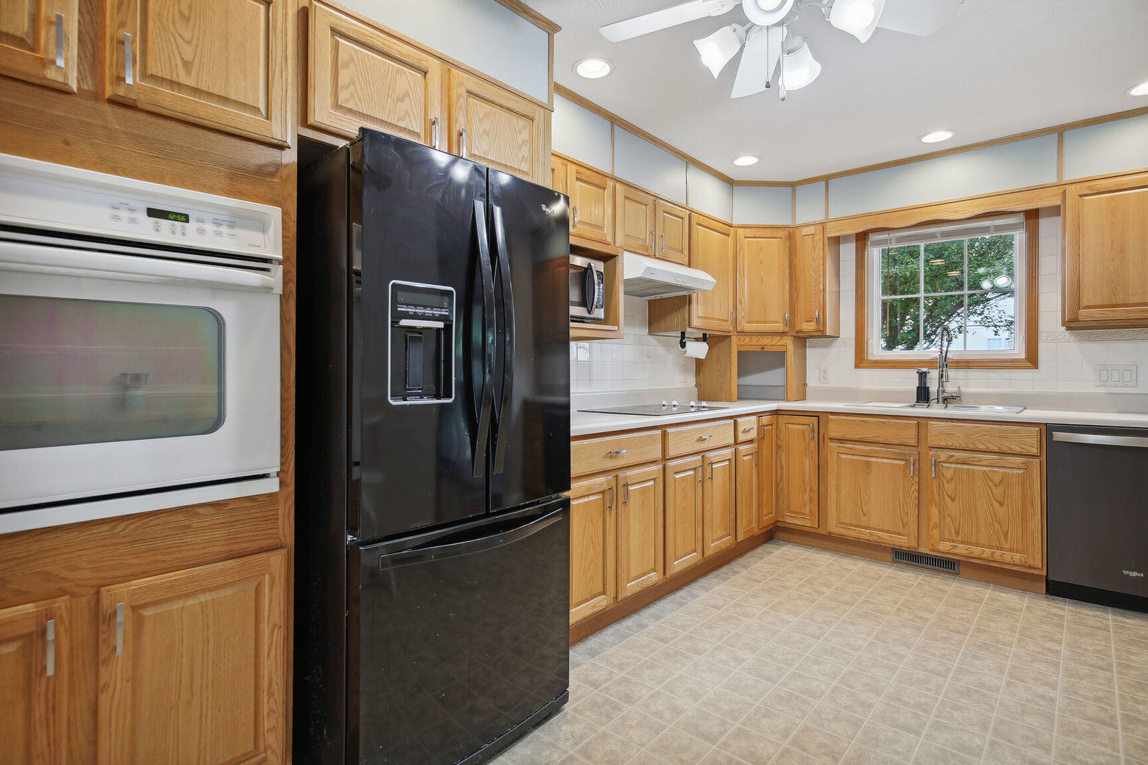 809 Lavender Drive Savoy, IL 61874 - Photo 9 of 27 a kitchen with stainless steel appliances a refrigerator sink and cabinets