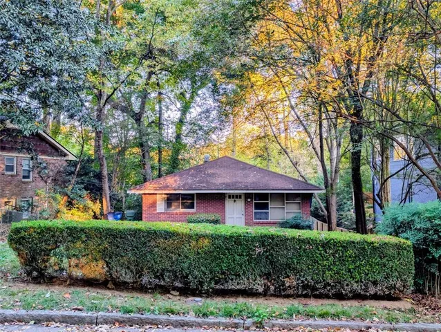 front view of a house with a tree