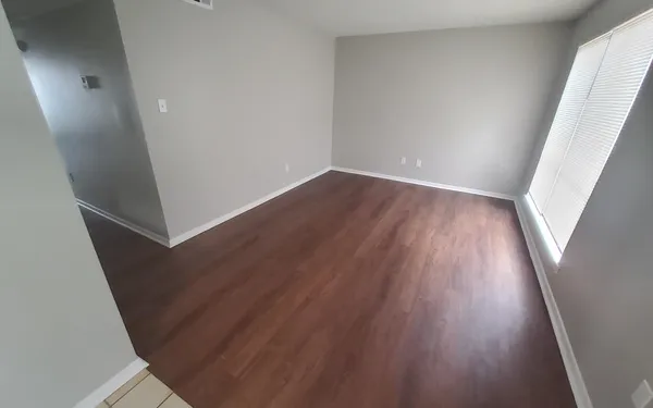 a view of room with window and hardwood floor