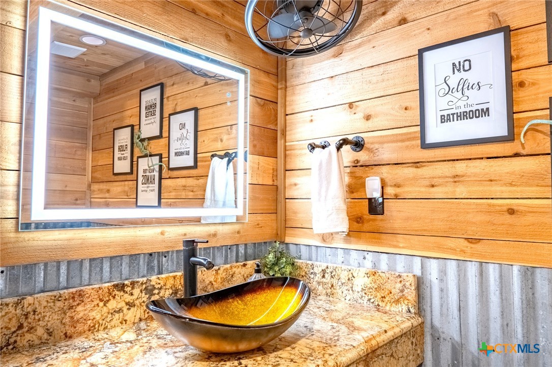 582 Cypress Valley Road Cuero, TX 77954 - Photo 14 of 46 a bathroom with a tub and a window