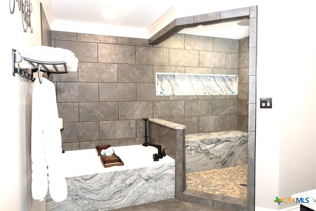 582 Cypress Valley Road Cuero, TX 77954 - Photo 26 of 46 a bathroom with a bathtub and shower