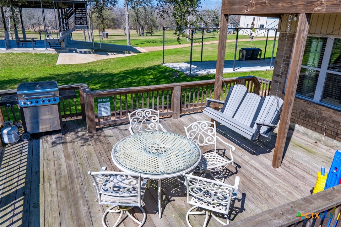 582 Cypress Valley Road Cuero, TX 77954 - Photo 27 of 46 a view of a chairs and table in patio with a yard