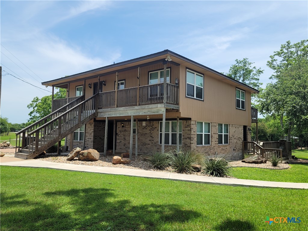 582 Cypress Valley Road Cuero, TX 77954 - Photo 3 of 46 a front view of a house with a yard