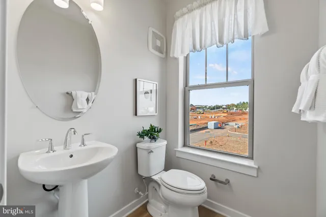 a bathroom with a sink toilet and mirror
