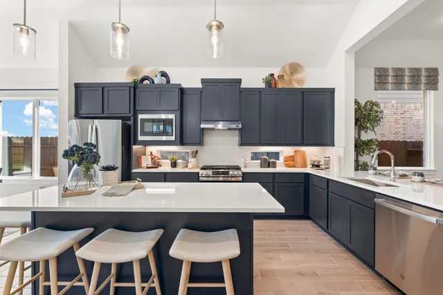 a kitchen with stainless steel appliances a sink and a refrigerator