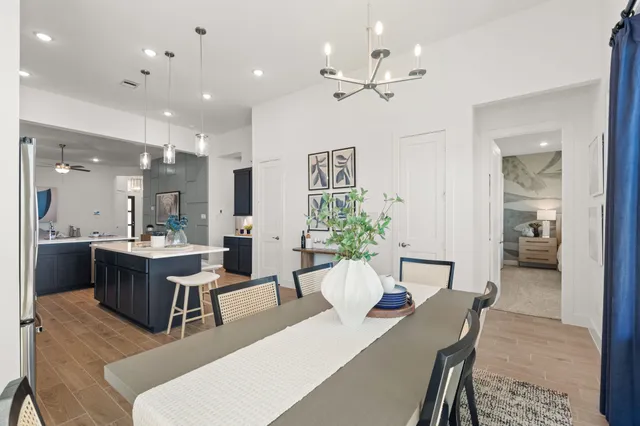 a view of a dining room with furniture and a chandelier