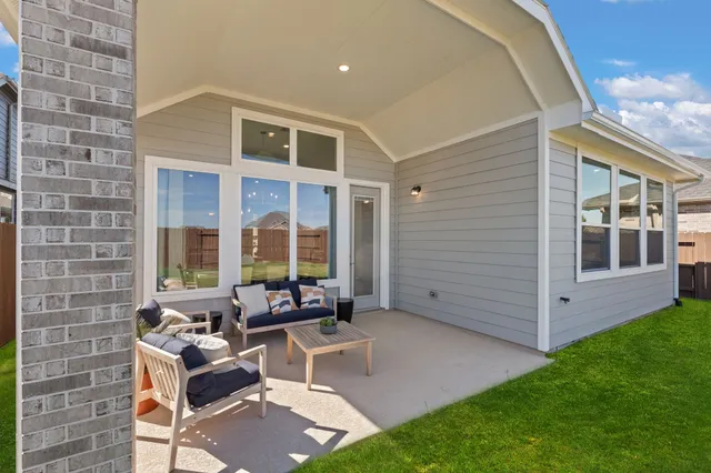 a view of an house with backyard and porch