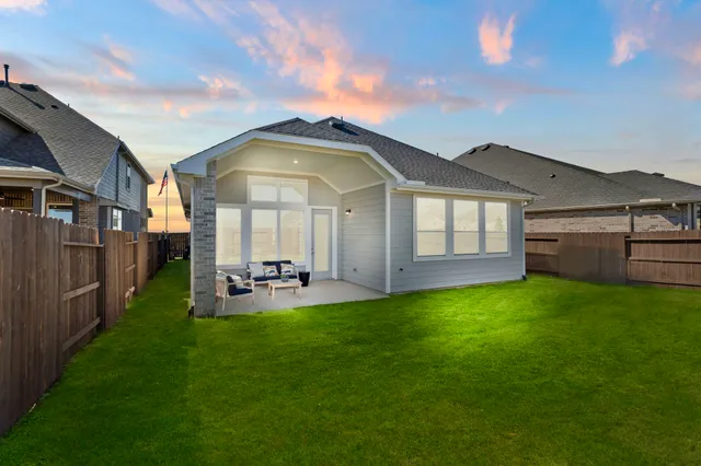 a view of a house with a garden and deck