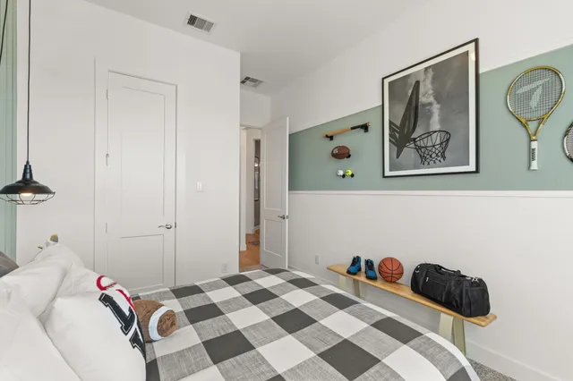 a bedroom with a bed and a painting on the wall