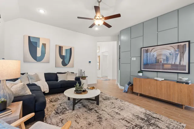 a living room with furniture and a painting on the wall