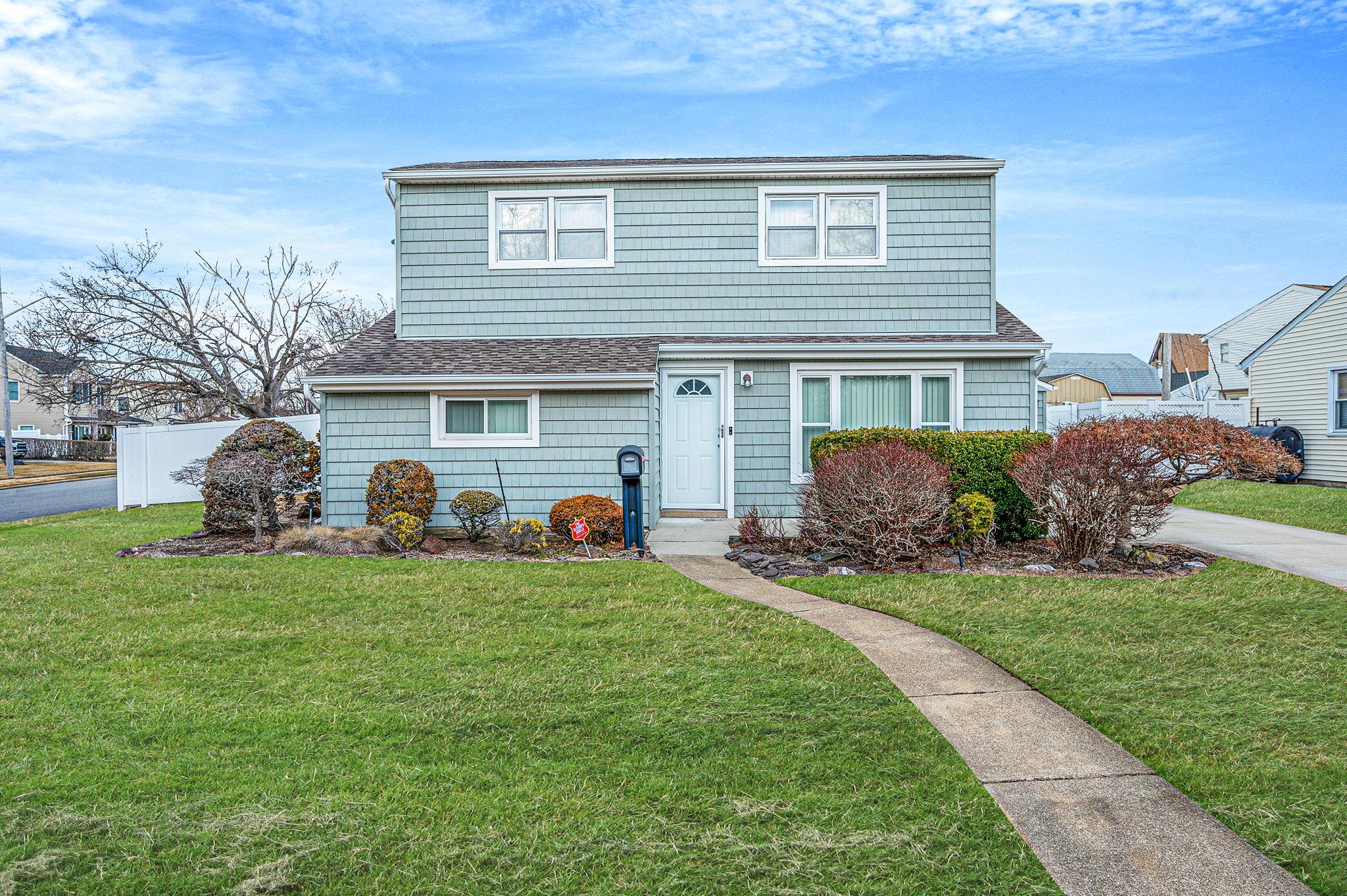 4162 Gloria Road Bethpage, NY 11714 - Photo 1 of 1 a front view of a house with a garden
