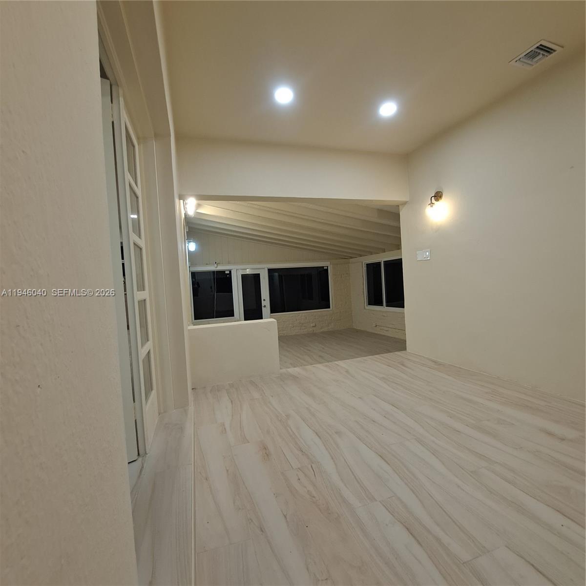 5840 Southwest 51st Street Miami, FL 33155 - Photo 3 of 15 a view of empty room with wooden floor