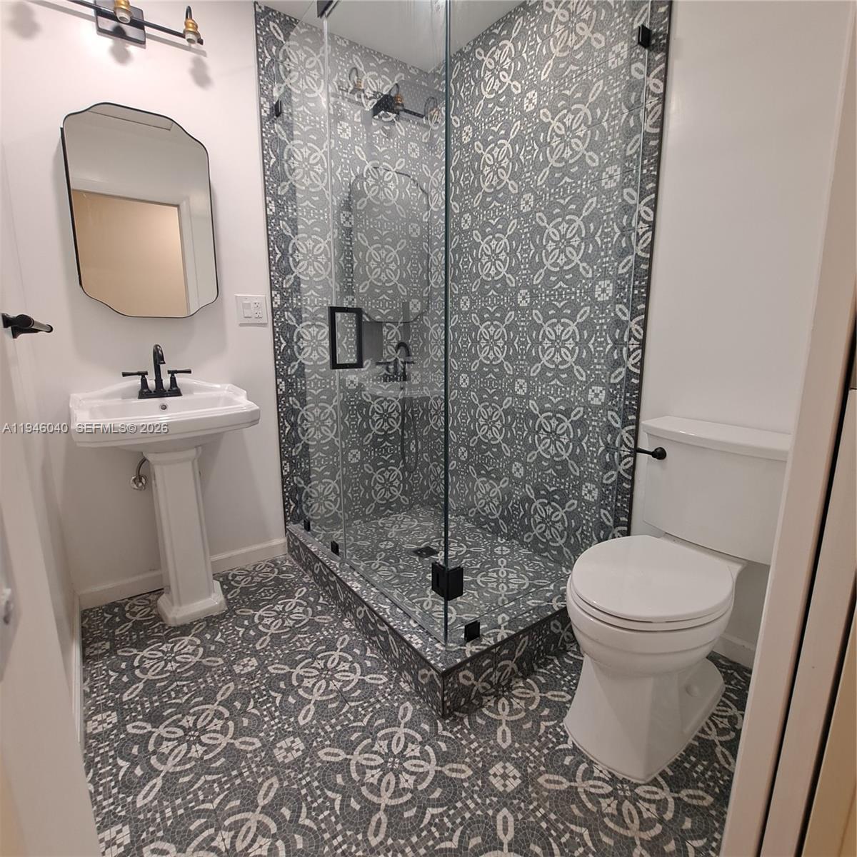 5840 Southwest 51st Street Miami, FL 33155 - Photo 10 of 15 a bathroom with a toilet sink and shower