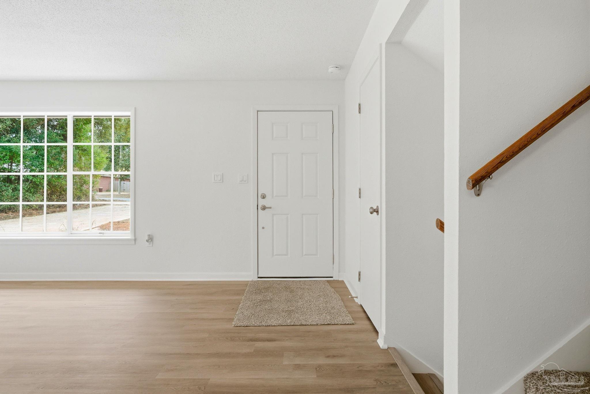 6534 Berryhill Road Milton, FL 32570 - Photo 14 of 38 a view of an empty room with wooden floor and a window