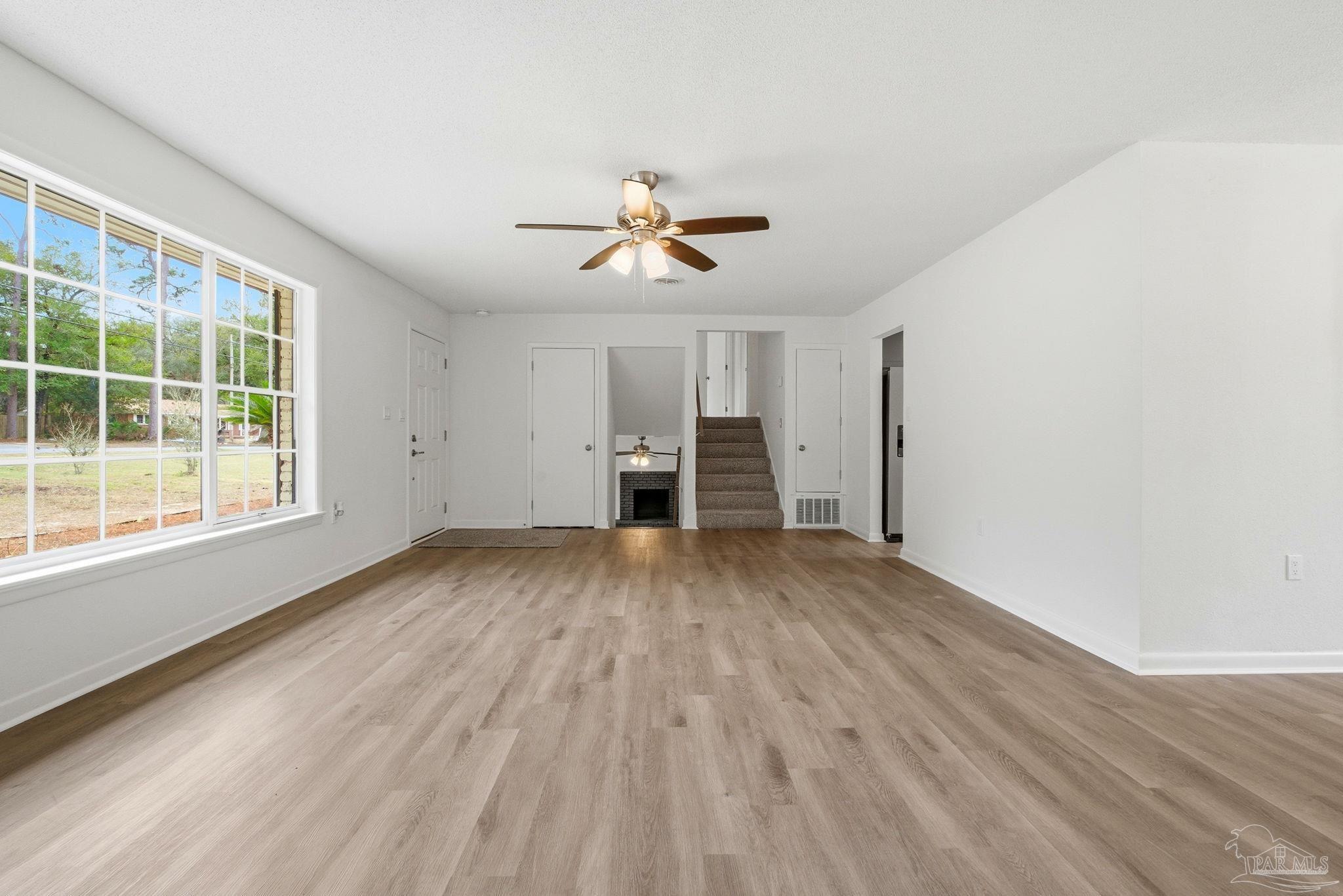 6534 Berryhill Road Milton, FL 32570 - Photo 17 of 38 a view of empty room with wooden floor and fan