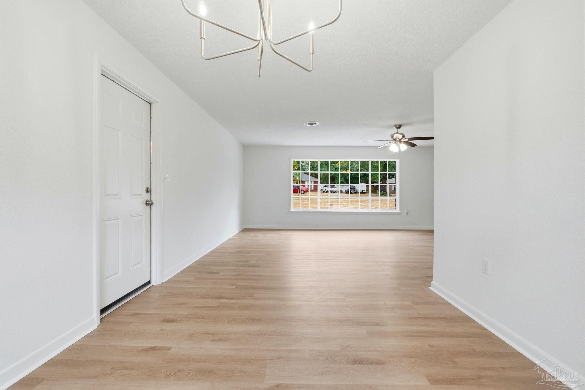 6534 Berryhill Road Milton, FL 32570 - Photo 20 of 38 a view of an empty room with a window and wooden floor