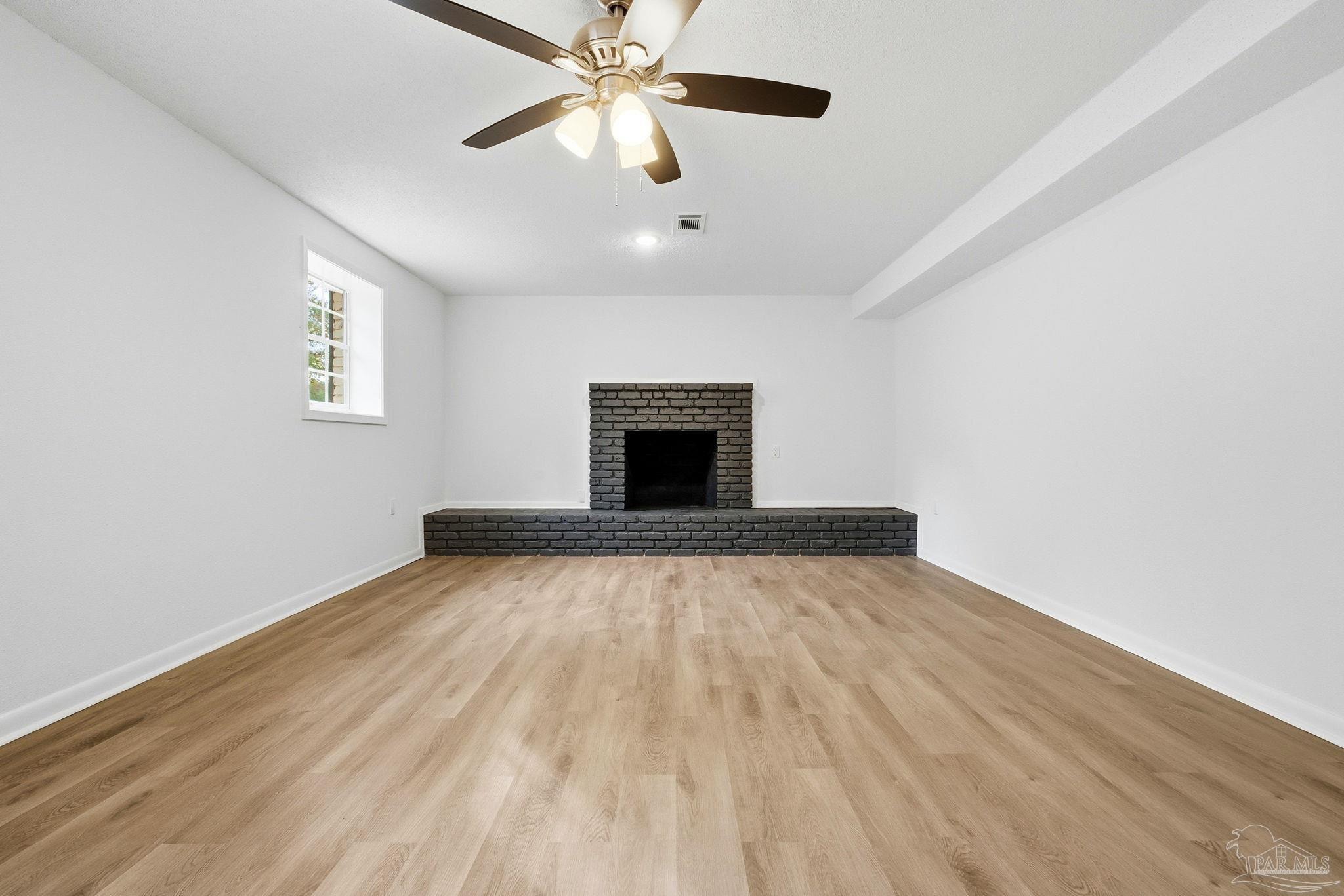 6534 Berryhill Road Milton, FL 32570 - Photo 21 of 38 an empty room with windows and fan