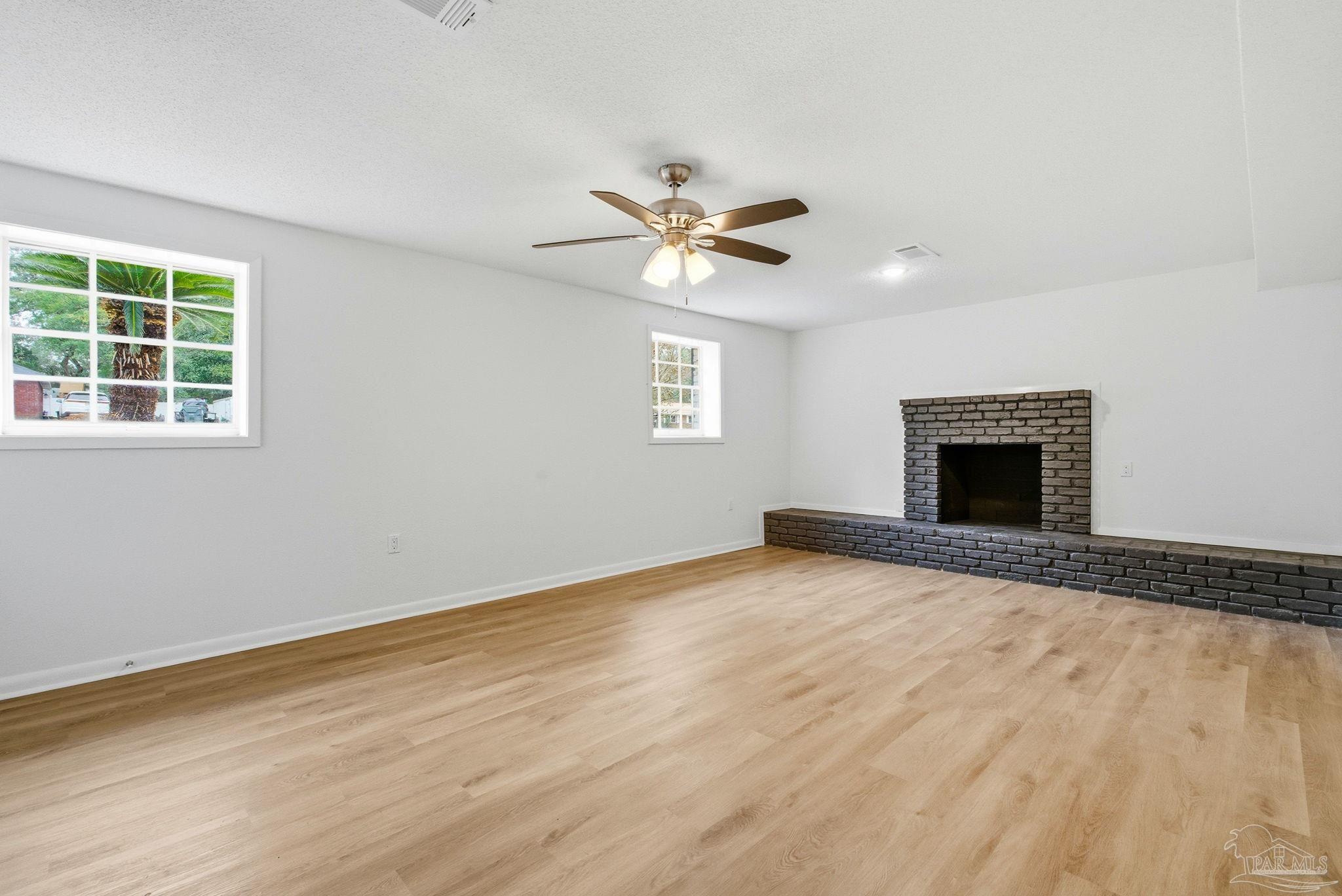 6534 Berryhill Road Milton, FL 32570 - Photo 22 of 38 an empty room with windows and fireplace