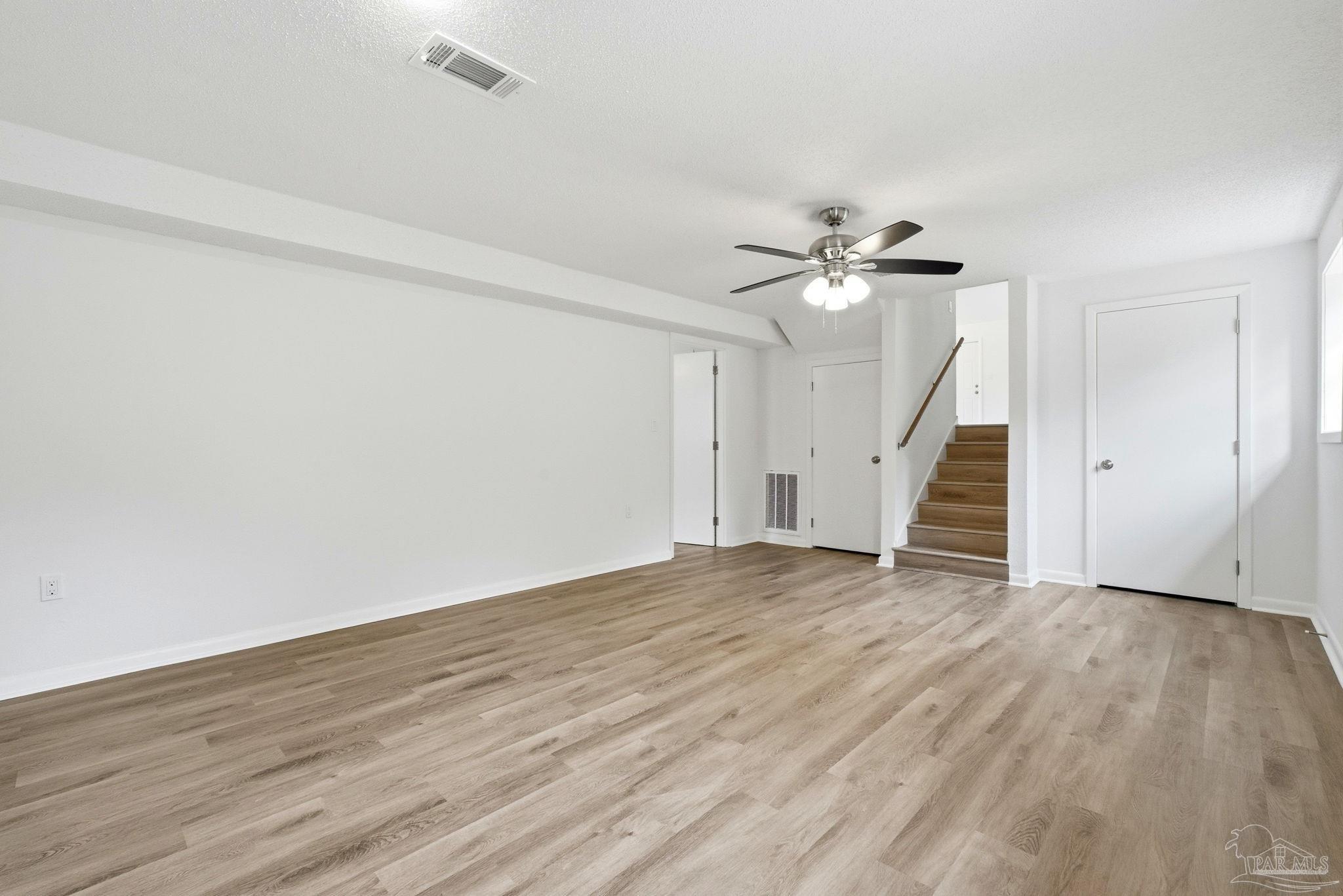 6534 Berryhill Road Milton, FL 32570 - Photo 23 of 38 wooden floor in an empty room with a ceiling fan