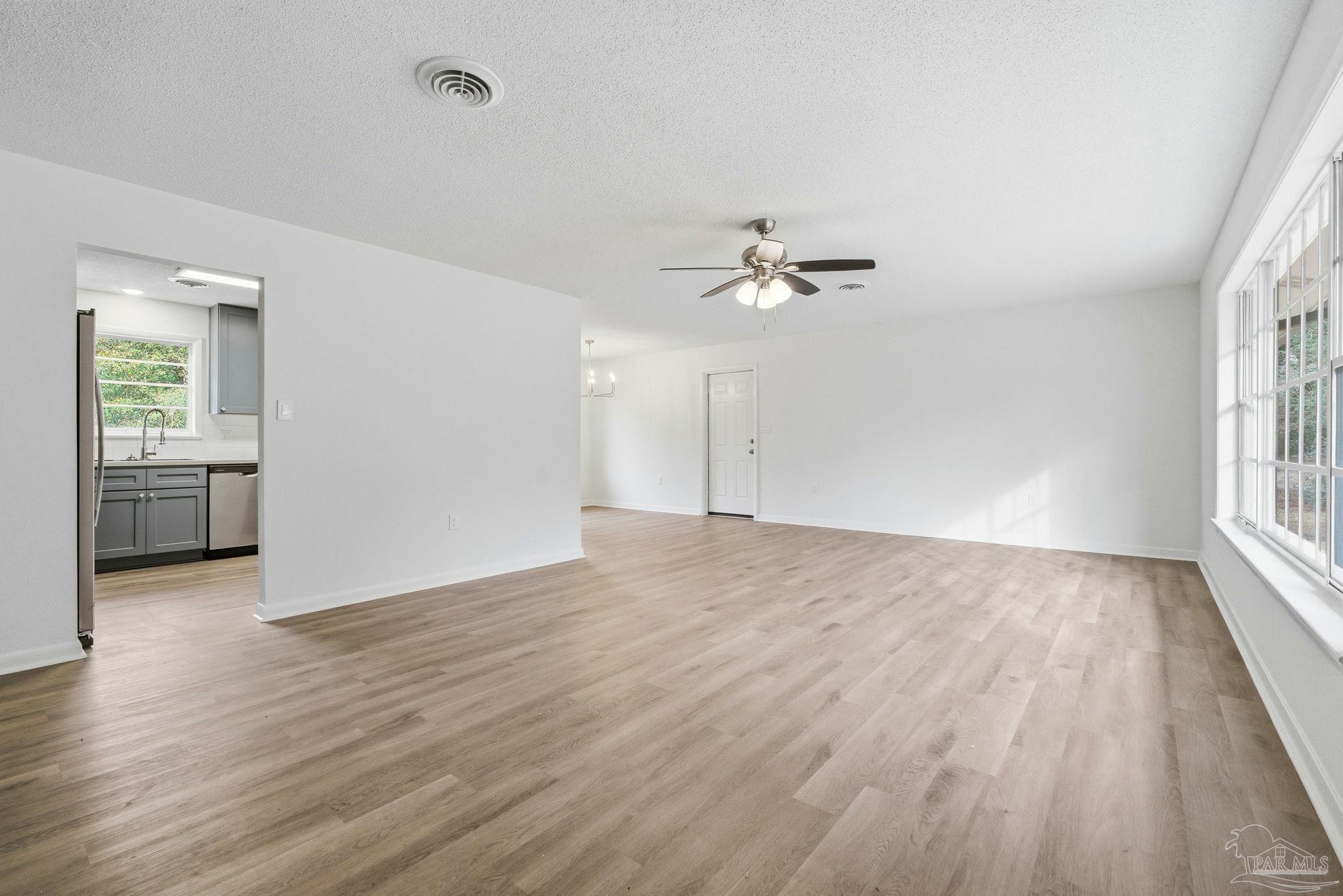 6534 Berryhill Road Milton, FL 32570 - Photo 26 of 38 a view of an empty room with wooden floor and a window