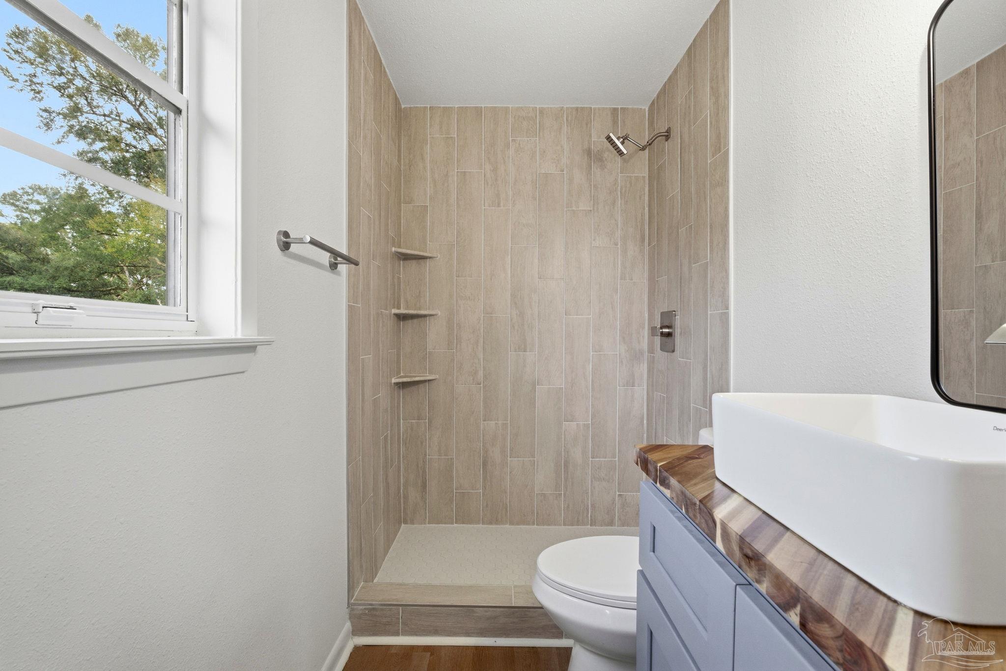 6534 Berryhill Road Milton, FL 32570 - Photo 28 of 38 a bathroom with a sink a toilet and shower