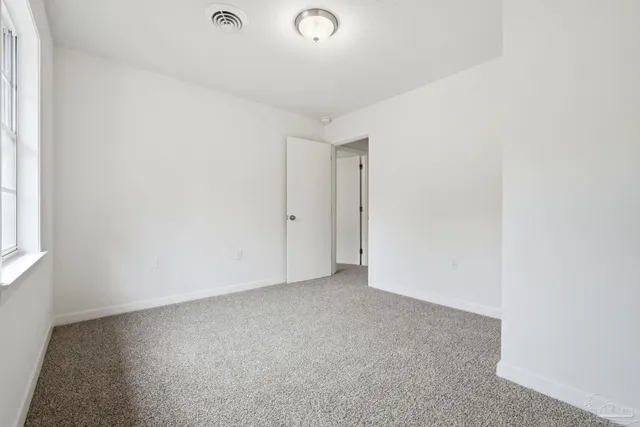 a view of a house with a yard and a garden