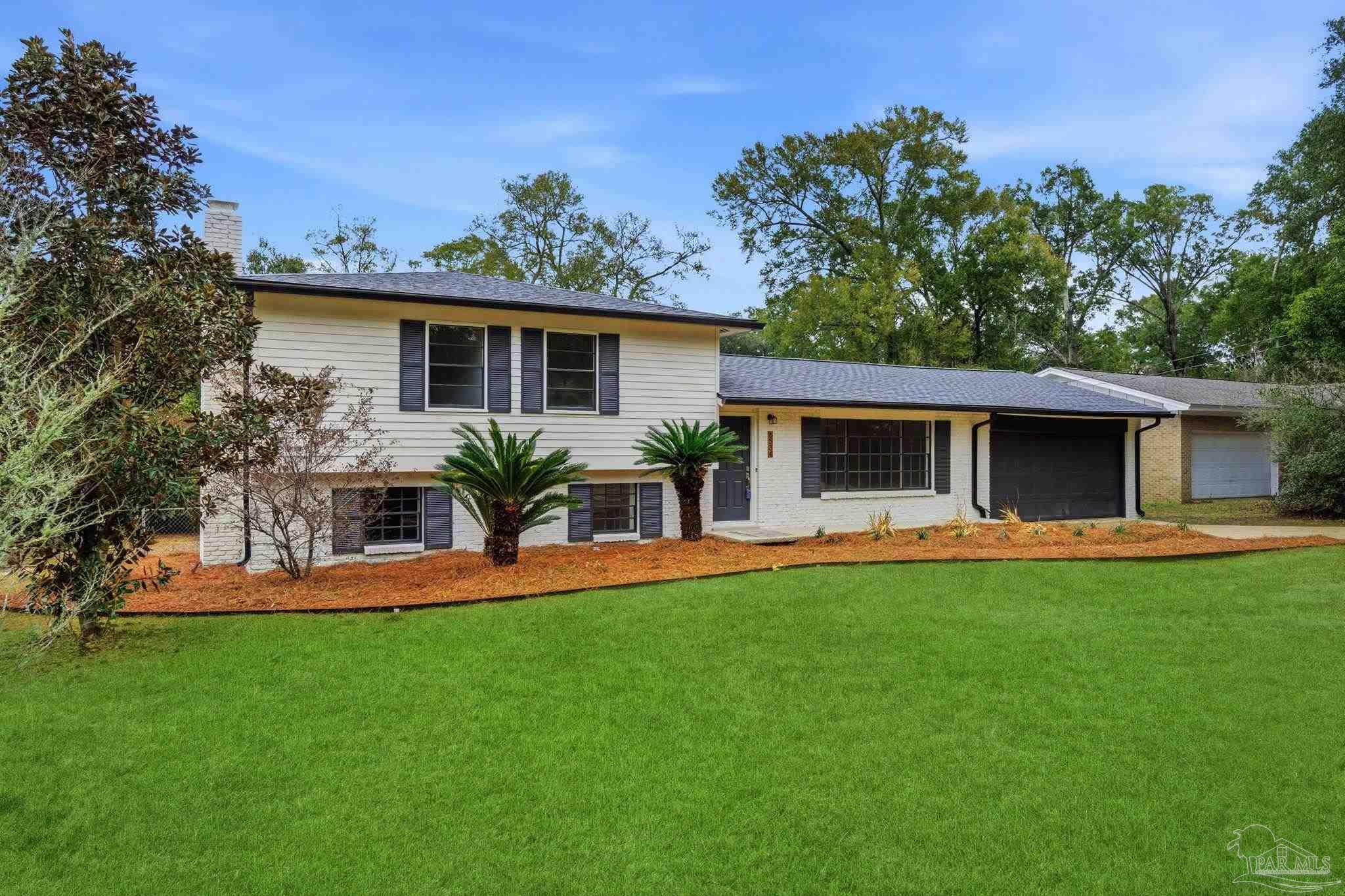 6534 Berryhill Road Milton, FL 32570 - Photo 38 of 38 a view of a house with a yard and a garden
