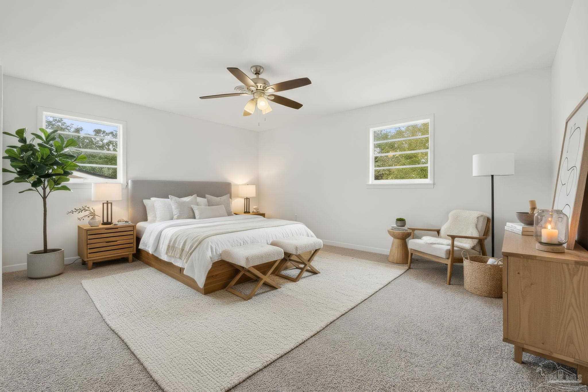 6534 Berryhill Road Milton, FL 32570 - Photo 6 of 38 a bedroom with a bed a couch and a potted plant