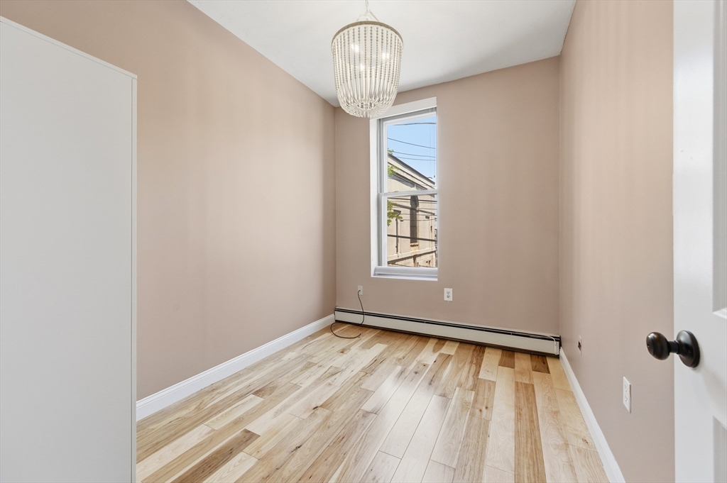 54 Beacon Street, Unit 2 Chelsea, MA 02150 - Photo 19 of 26 a view of empty room with wooden floor and fan