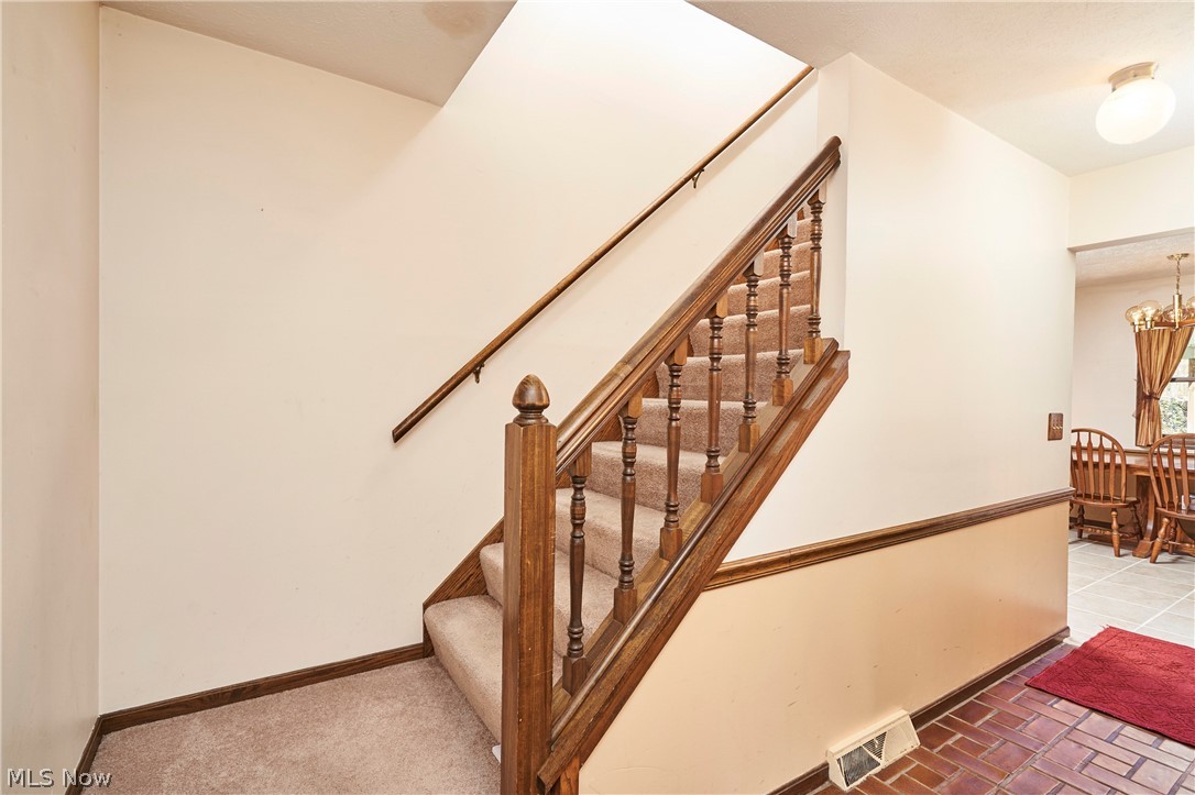 3097 Baughman Road Clinton, OH 44216 - Photo 10 of 27 Carpeted staircase with wooden balusters and handrail