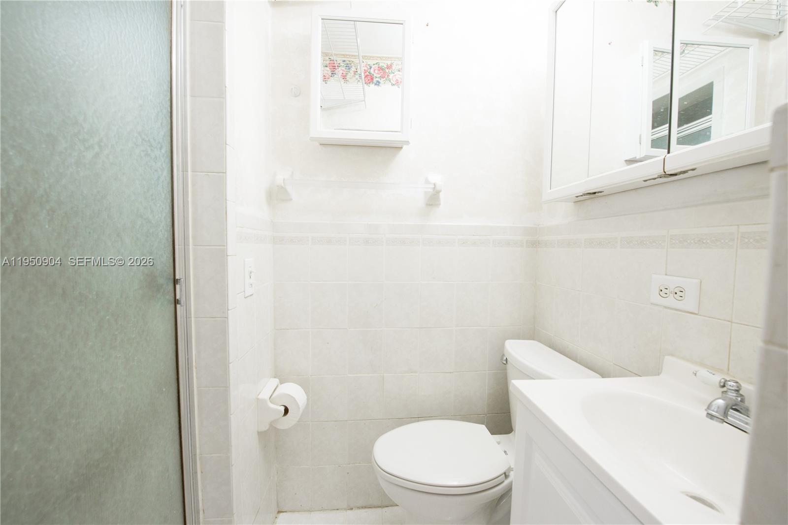 5431 West 2nd Avenue Hialeah, FL 33012 - Photo 12 of 24 a white toilet sitting next to a bathroom sink