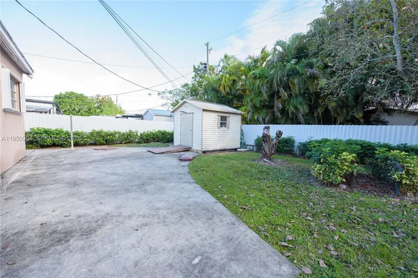 a view of a house with a yard and potted plants