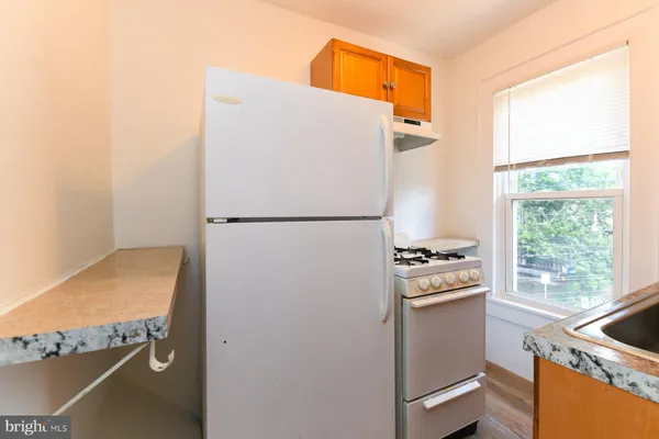 a kitchen with a refrigerator and a window