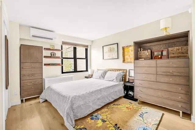 a dining room with furniture window and wooden floor