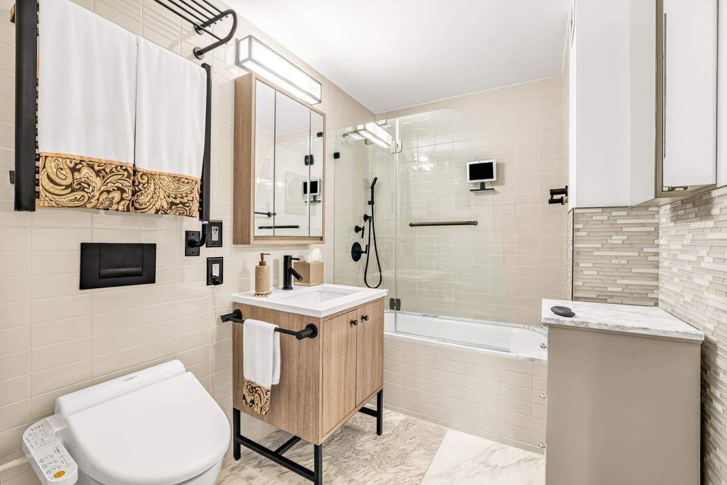 175 West 95th Street, Unit 2C Manhattan, NY 10025 - Photo 9 of 18 a bathroom with a sink toilet and shower