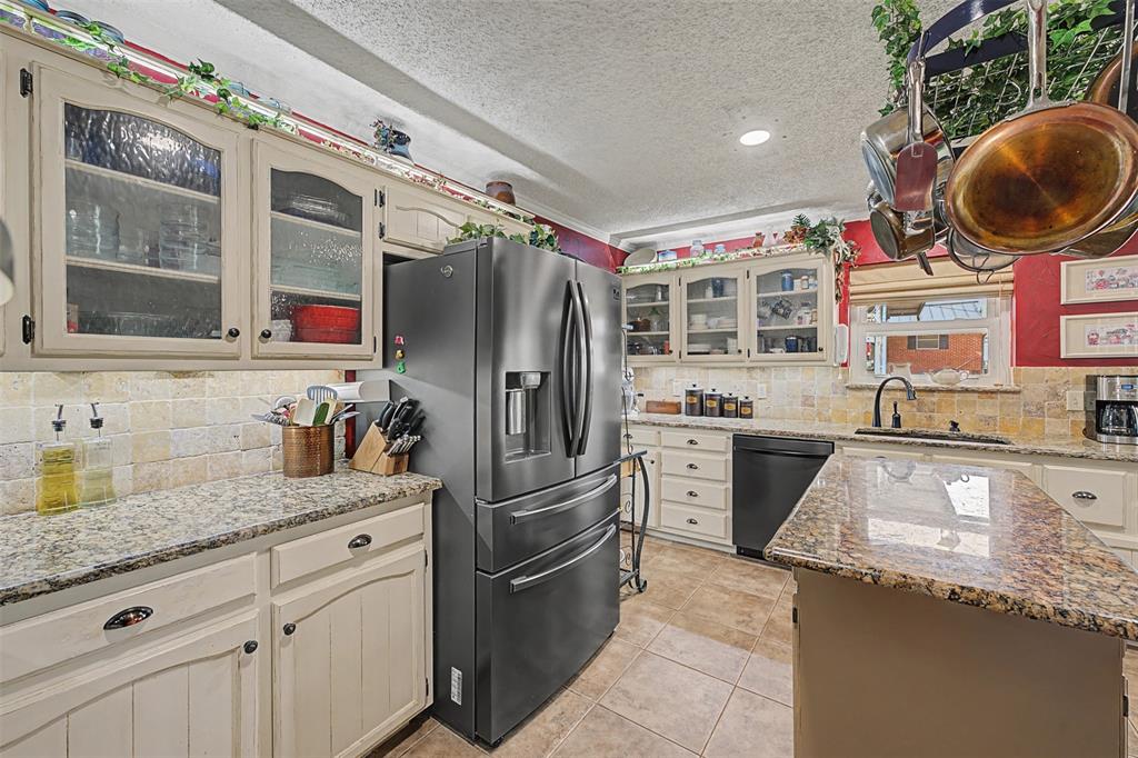 8240 Kramer Street Burleson, TX 76028 - Photo 12 of 39 a kitchen with granite countertop a sink stainless steel appliances and cabinets