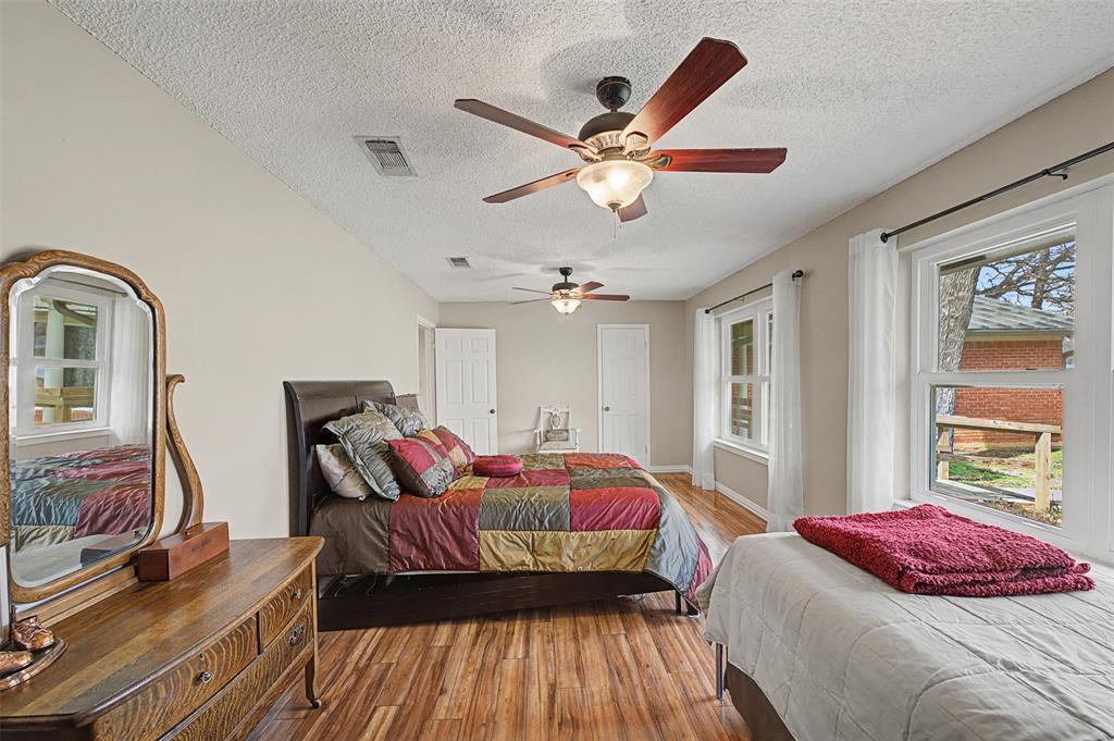 8240 Kramer Street Burleson, TX 76028 - Photo 22 of 39 a bedroom with a bed and wooden floor