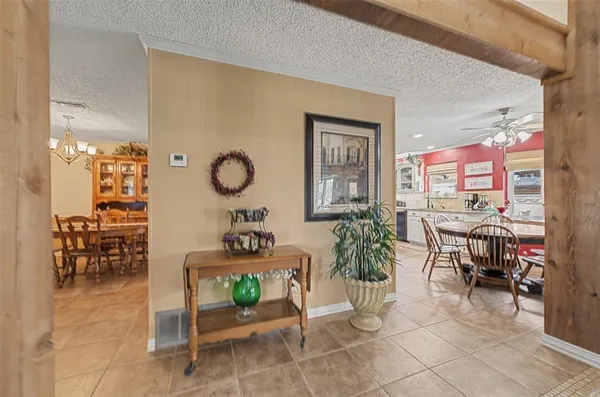 a living room with furniture a dining table and a potted plant
