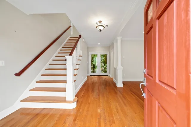 a view of entryway with wooden floor and stairs