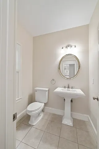 a large kitchen with kitchen island granite countertop wooden floors and wide window