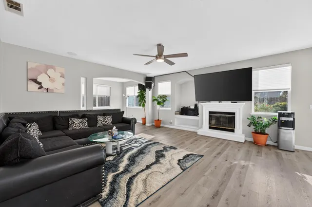 a living room with furniture a fireplace and a flat screen tv