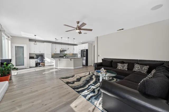 a living room with furniture and kitchen view