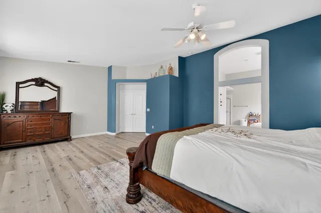 a bedroom with a bed and a dresser