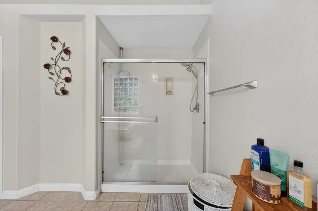 a bathroom with a shower a toilet and a sink