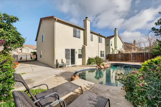 a view of a patio with couches table and chairs and potted plants