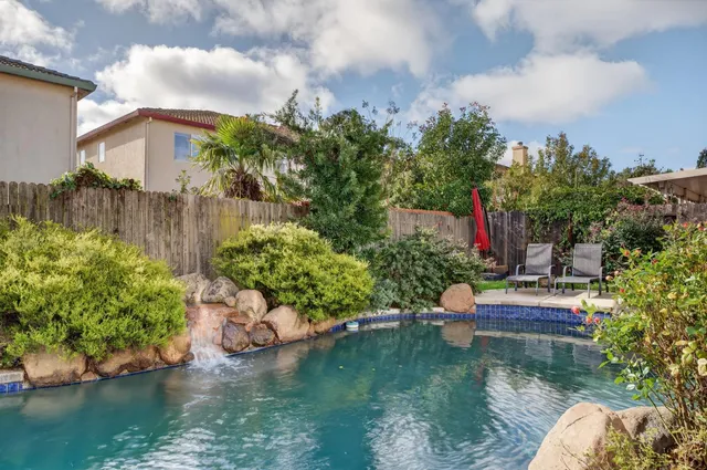 a backyard of a house with a yard and outdoor seating